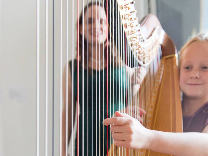 Young lady at a harp lesson with Kristie Smith.